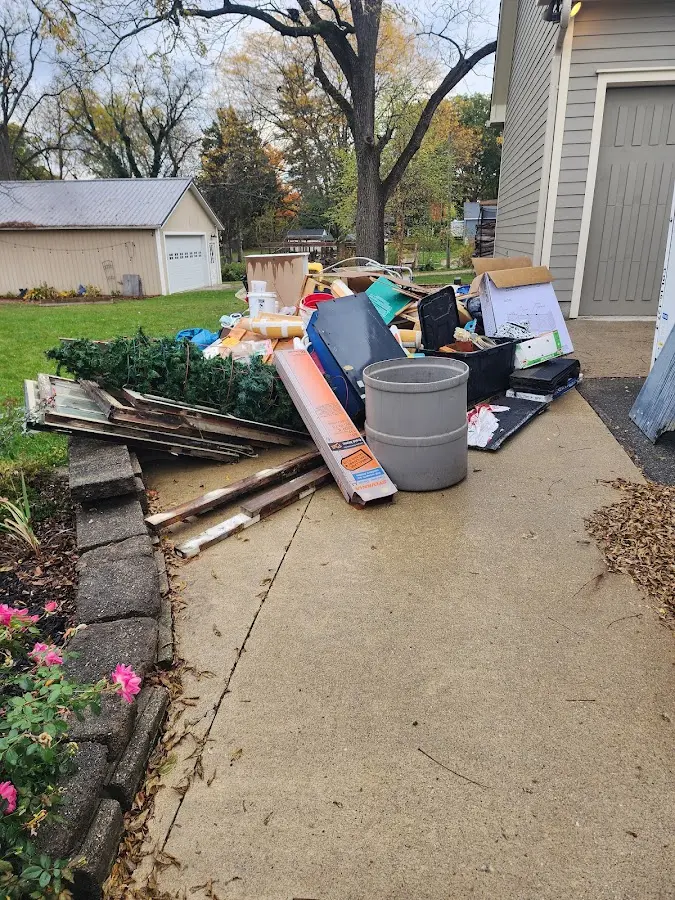Dumpster being loaded with debris for 30 Yard Dumpster Rental in Monroe